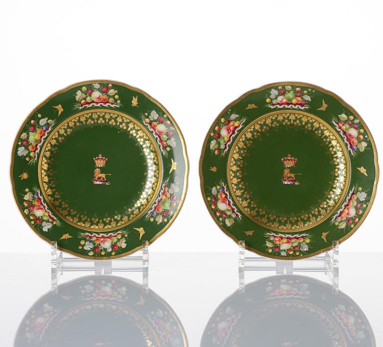 A pair of armorial butter tureens with covers and stands and two fruit dishes, Derby, England, circa 1830.