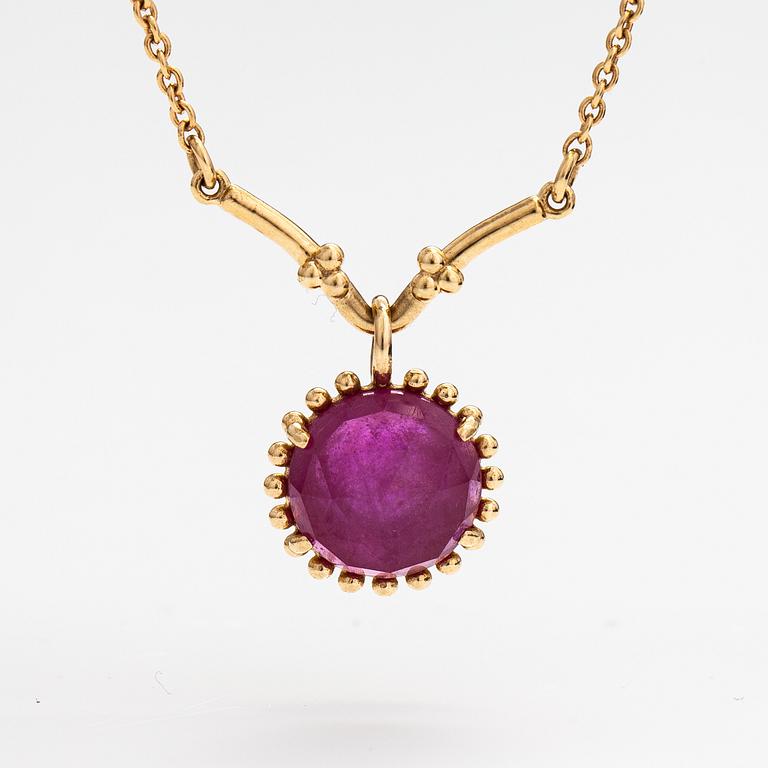 Pandora, a necklace with a lead glass treated ruby.