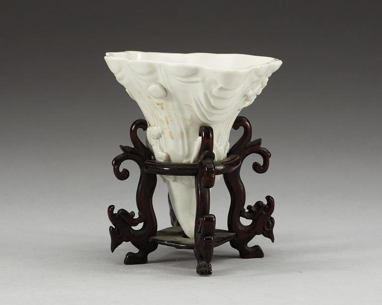 A blanc de chine libation cup in the shape of a rhinoseroushorn, Qing dynasty, Kangxi (1662-1722).