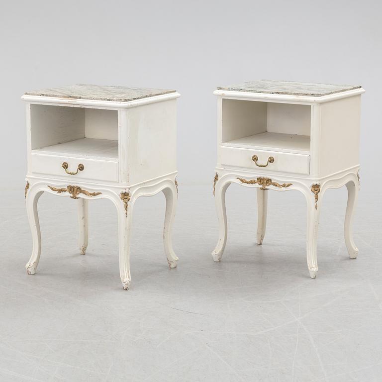 A pair of early 20th century rococo style bedside tables with marble top.