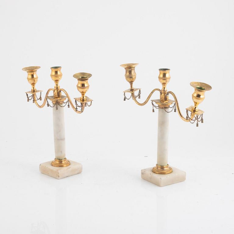 A pair of late Gustavian three-light white marble and gilt brass candelabra, late 18th century.