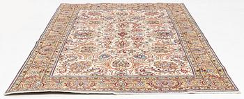 A signed Tabriz carpet, c 309 x 205 cm.