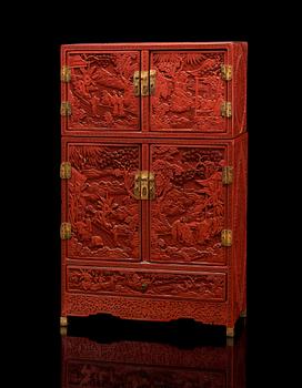 A well carved Cinnaber lacquer 'Kang'Cabinet, Qing dynasty, 18/19th Century.