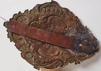 A pair of North European Rococo two-branch repoussé brass reflector plates, mid 18th century.