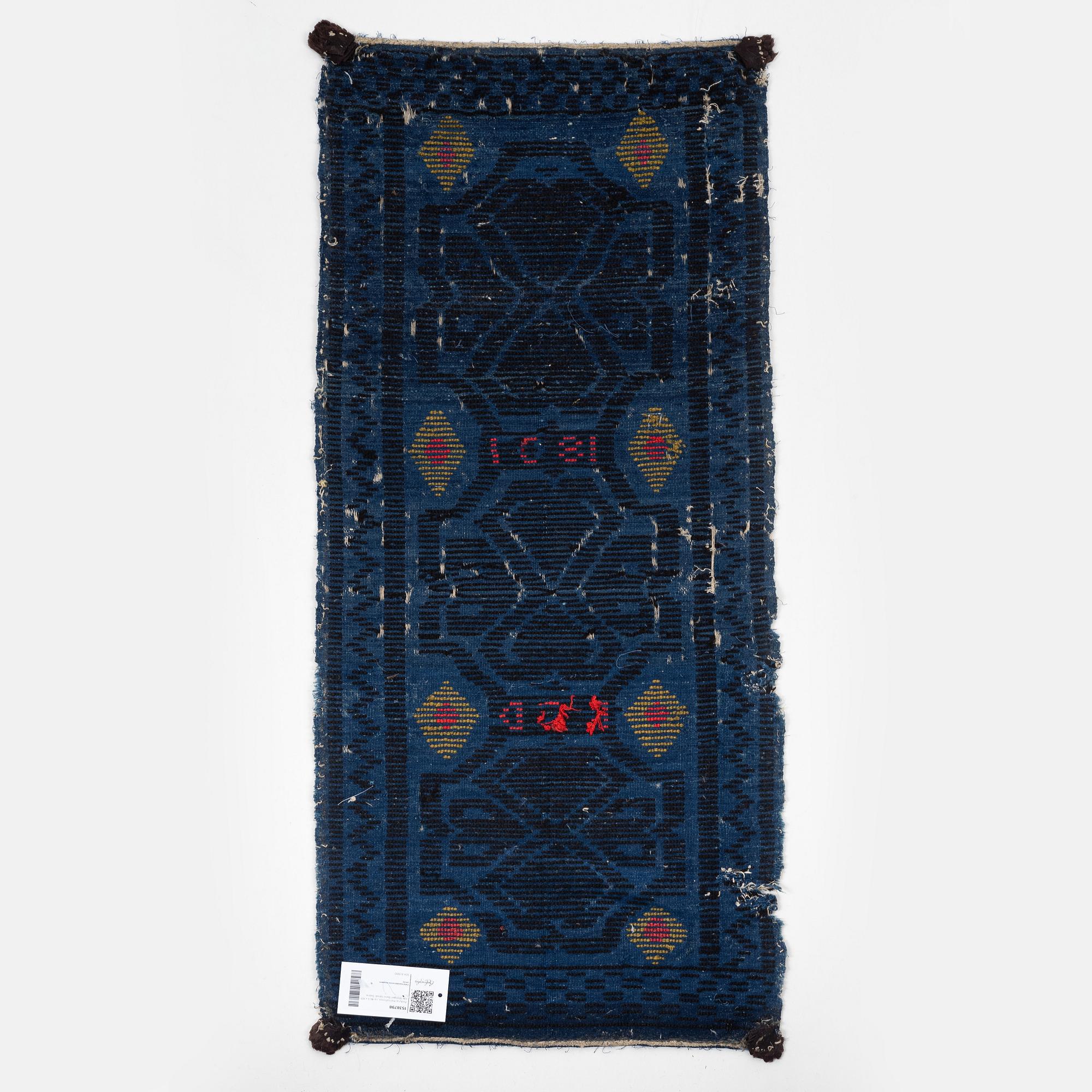 A carrige cushion, knotted pile in relief, ca 46,5 x 101 cm probably Bara district, Scania, Seeden.
