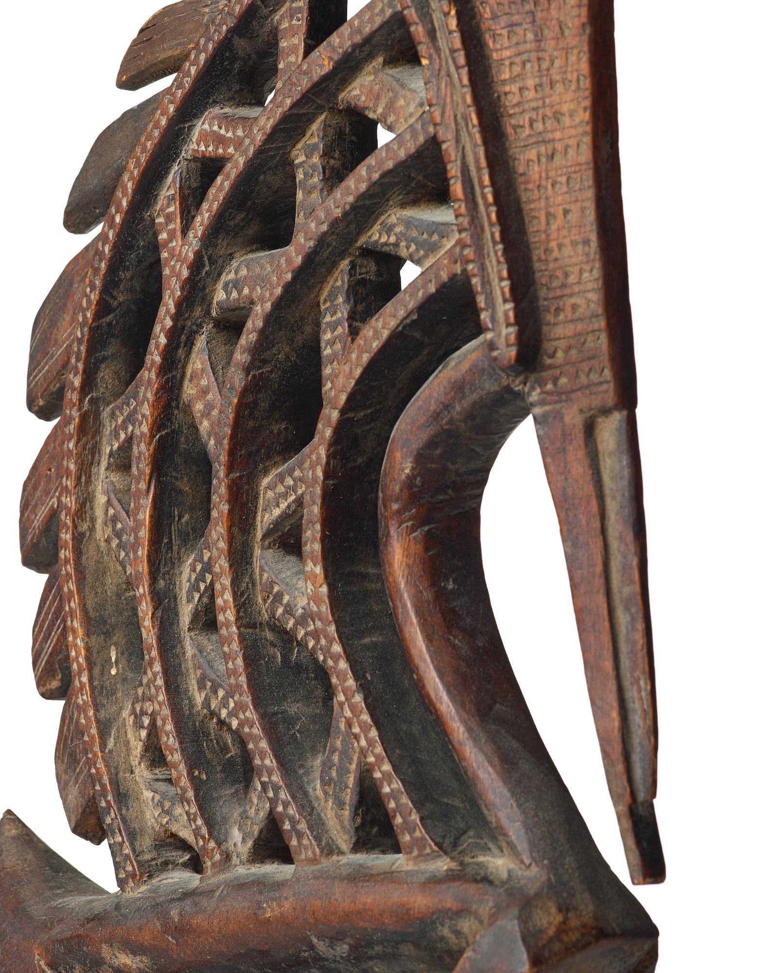 A SCULPTURE, a headdress, Tshiwara/Ciwara (stylized male antelope), wood, the Bambara tribe, Mali, h. 94 cm. On a base.