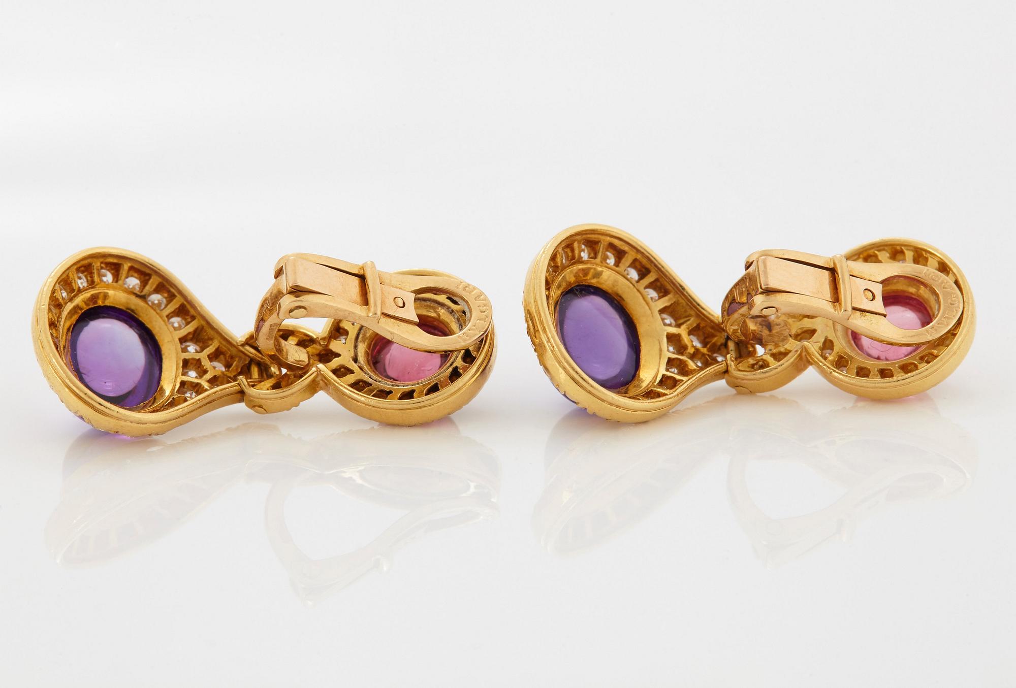 A pair of 18K gold Bulgari earrings set with cabochon-cut amethyst and tourmaline.