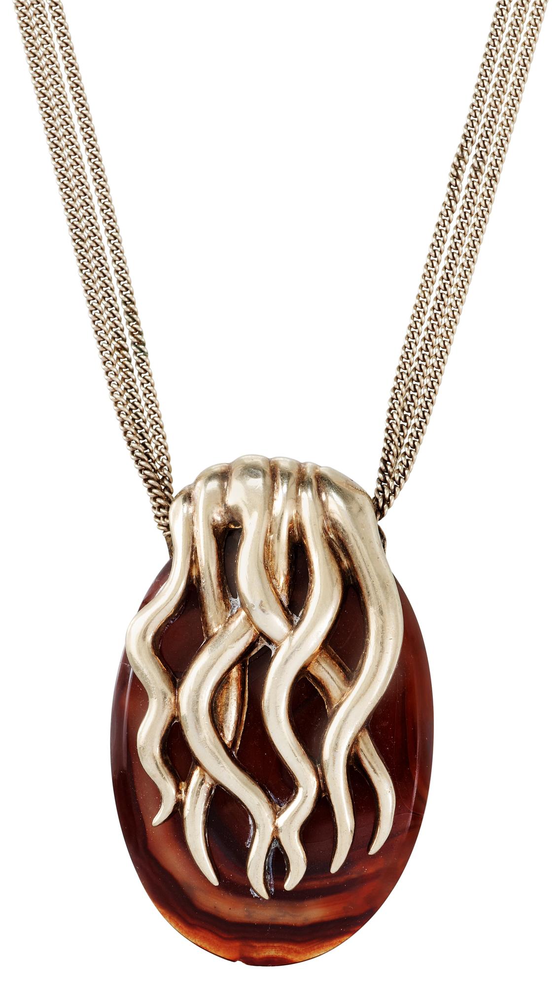 An Estrid Ericson amber and gilt pewter pendant.