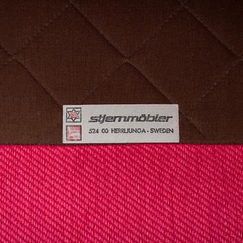 An 'Oxford' model no 3543 easy chair with stool by Ragnar Helsén for Firma Svenskt Tenn.