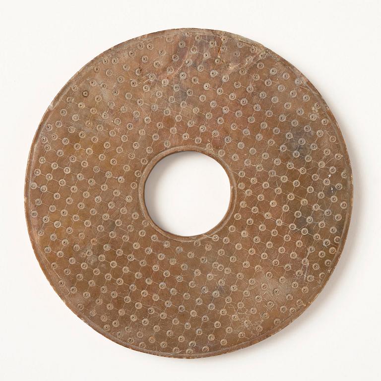 A stone bi disc, Han dynasty (206 B.C.-220 A.D.).