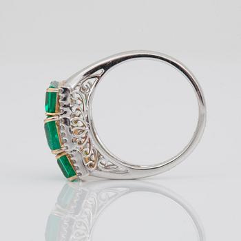 An emerald and brilliant-cut diamond ring. Total carat weight on emeralds 4.04 cts. Carat weight on diamonds 0.14 ct.