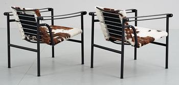 A pair of Le Corbusier 'LC-1' black lacuered steel and cow hide armchairs, Cassina, Italy.