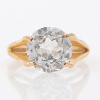 Ring, 18K gold with a synthetic white stone.