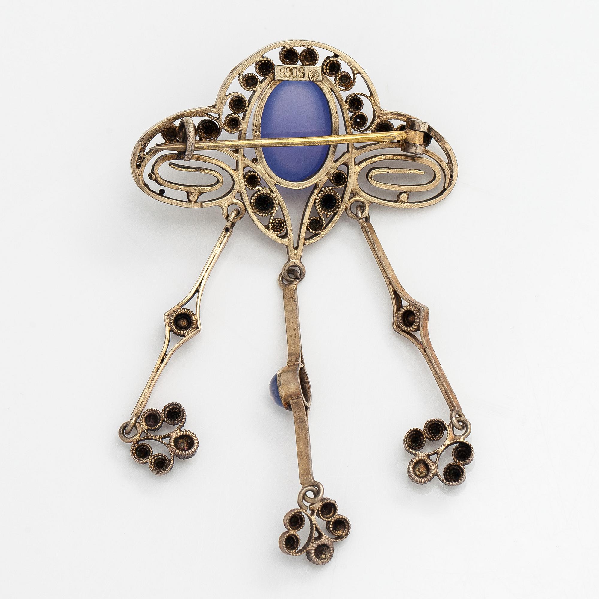 Brooch, cabochon-cut moonstones, gilded silver.