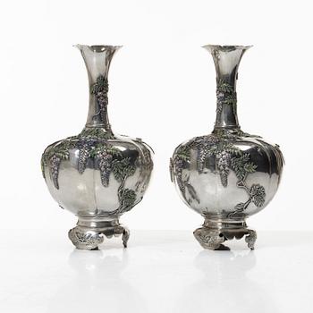 A pair of Japanese 'wisteria' silver vases, Meiji (1868-1912).