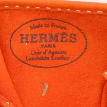 HERMÈS, a pair of orange lambskin leather gloves.