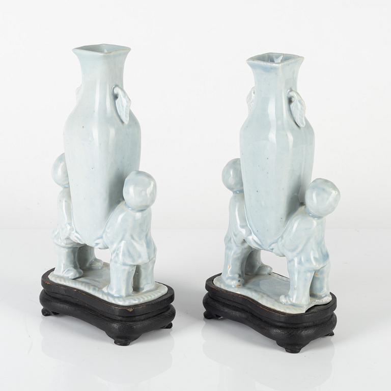 A pair of Chinese pale blue boys vases, around 1900.