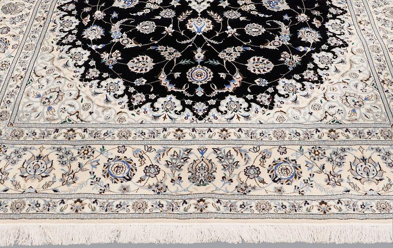 A Nain part silk carpet, 310 x 204 cm.