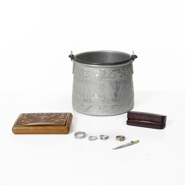 An aluminium bucket, a wooden case, four rings and two miniature knives, Finland and Russia, early 1900s.