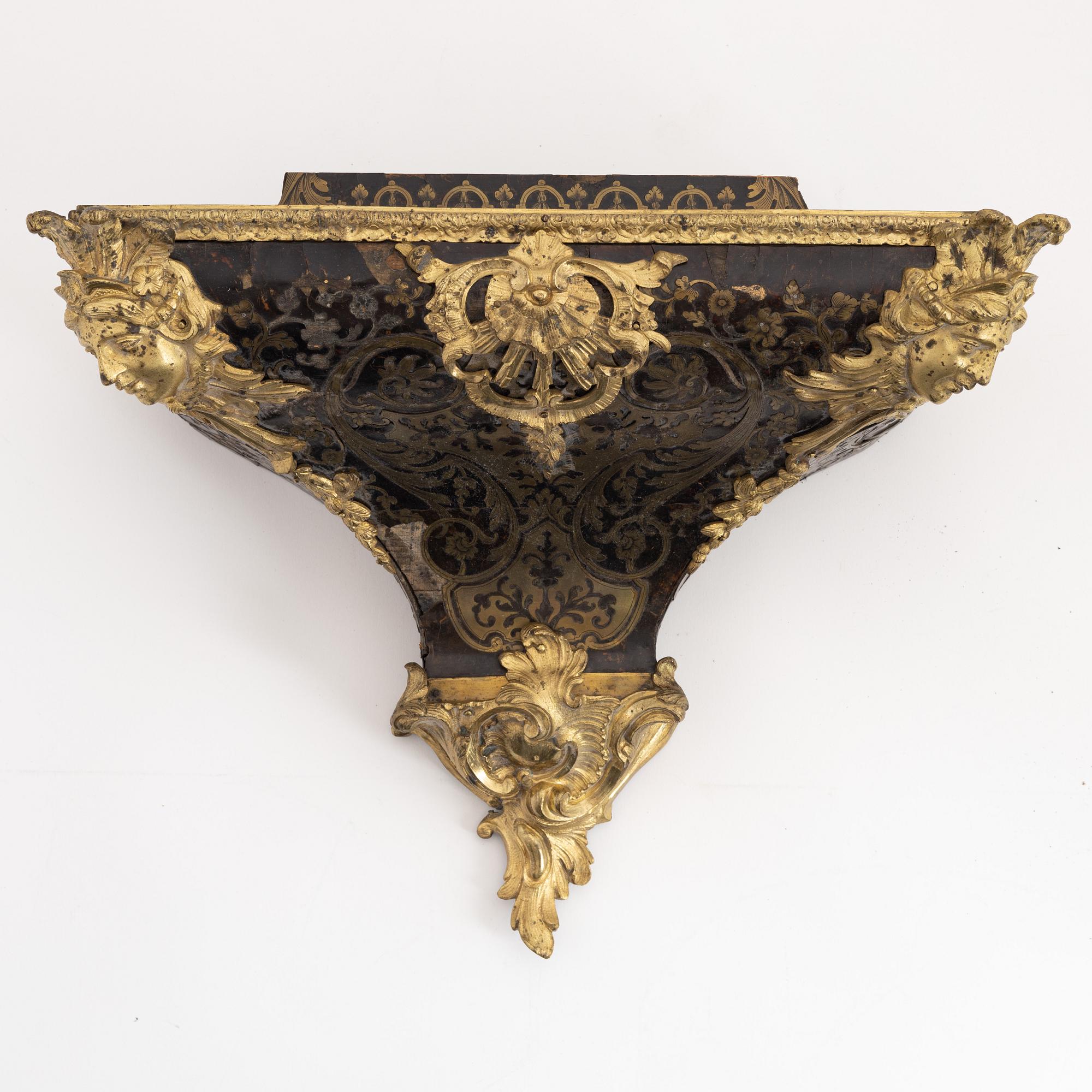 A 19th century rococo style clock, and a 18th century rococo console.