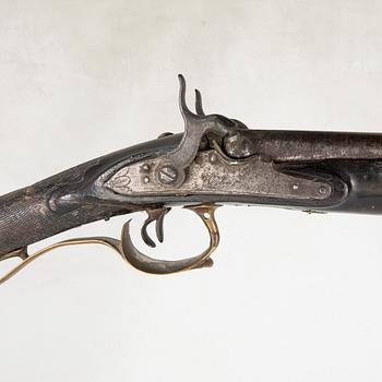 A double barreled percussion gun, 19th century.