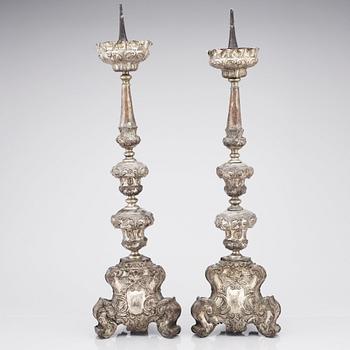 A pair of argente haché Baroque floor candlesticks, presumably Italy 18th century.