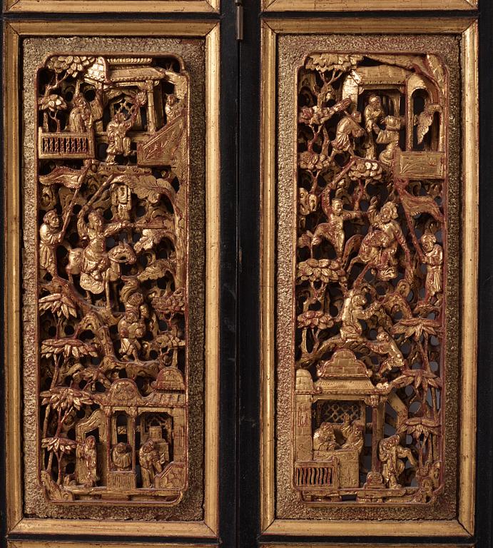 A set of four framed wooden panels, Qing dynasty, 19th Century.