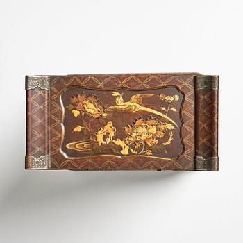A Japanese lacquer cabinet on a stand, Meiji period (1868-1912).