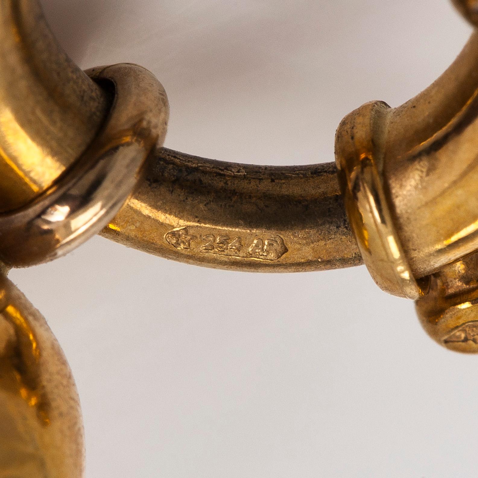 Rannekoru, 18K kultaa ja granaatteja.