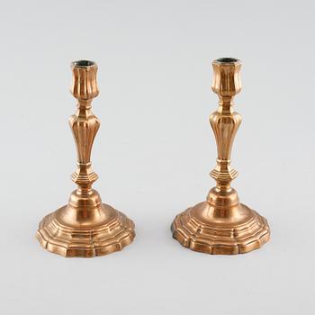 A pair of late barouqe bronze candlesticks, 18th century.