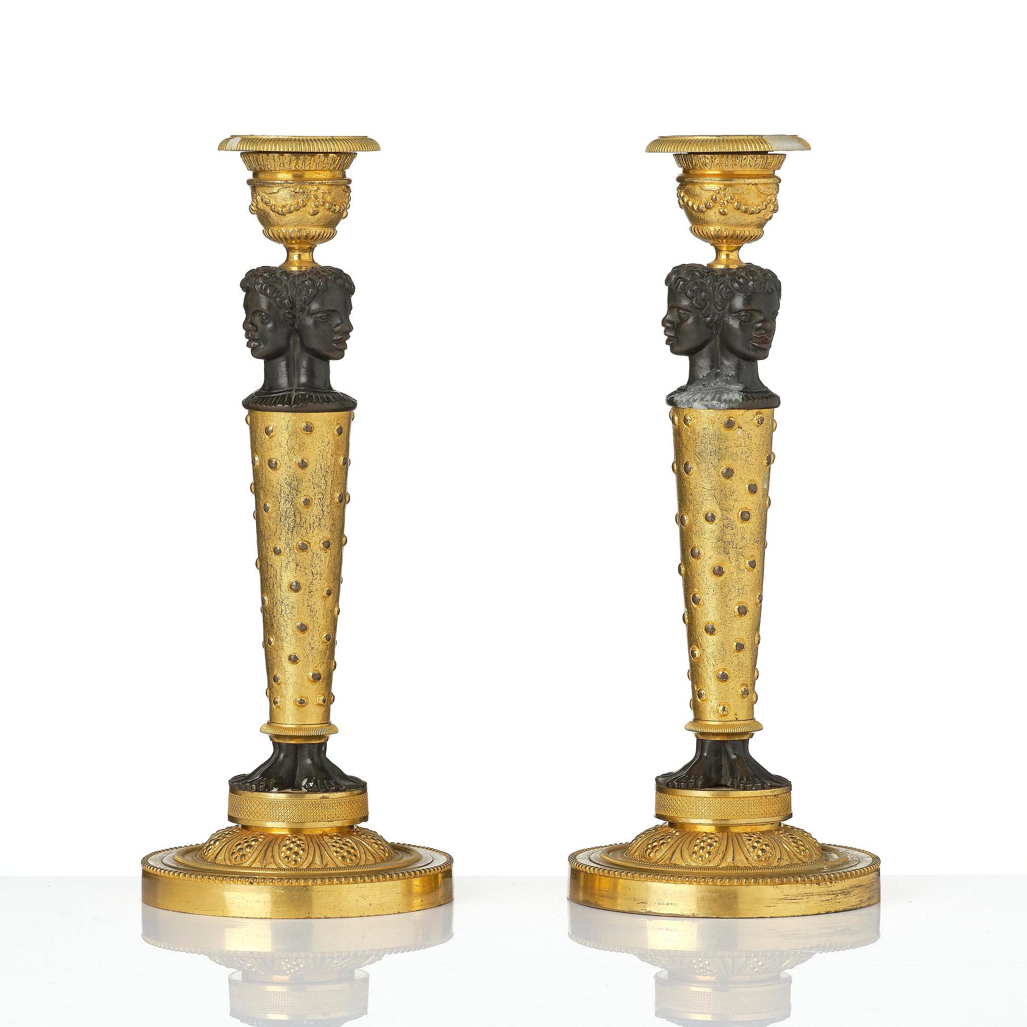 A pair of Napoleon III gilt and patinated bronze candlesticks, later part 19th century.