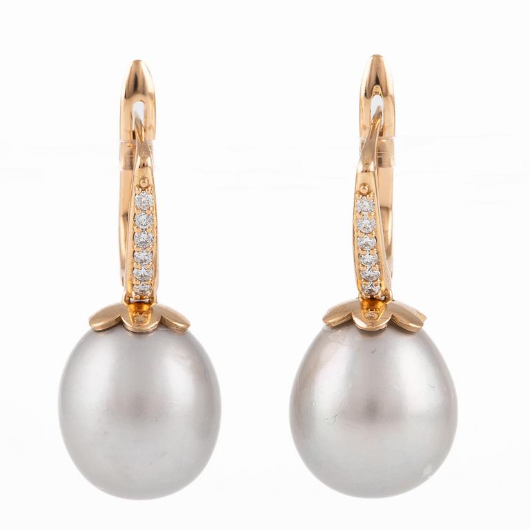 A pair of earrings in 18K gold with cultured freshwater pearls and round brilliant-cut diamonds.