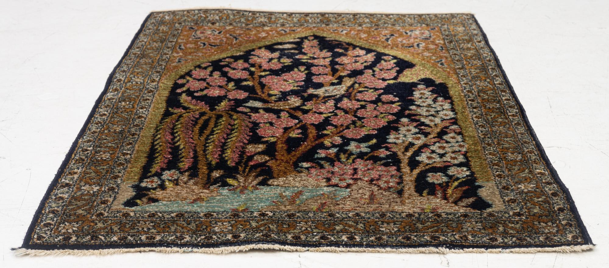 A semi-antique silk Ghom rug, central Iran, c. 32 x 23 in.