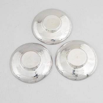 A set of three Japanese silver coasters and a pair of salts with shakers, 20th century.