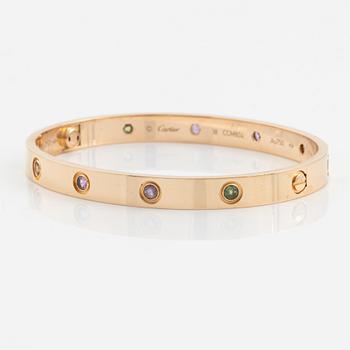A Cartier "Love" bracelet in 18K rose gold set with colored stones.