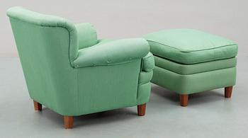 A Josef Frank armchair with ottoman, by Svenskt Tenn, model 568.