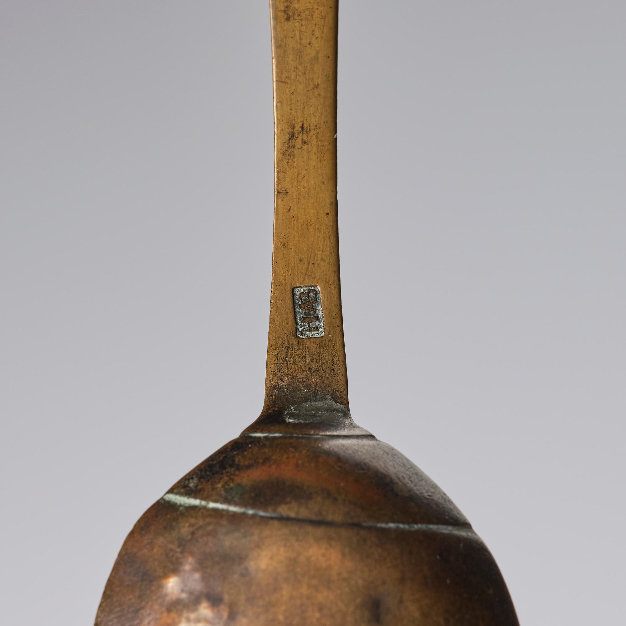 A set of three brass spoons, 18th century.