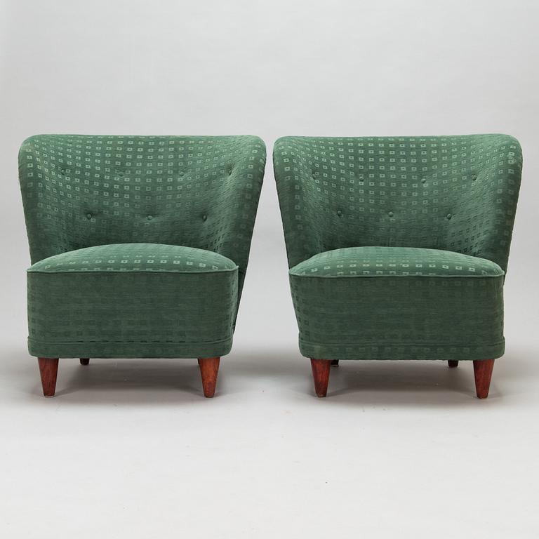 A pair of mid-20th-century armchairs.