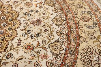 An oriental silk rug, diameter c. 216 cm.