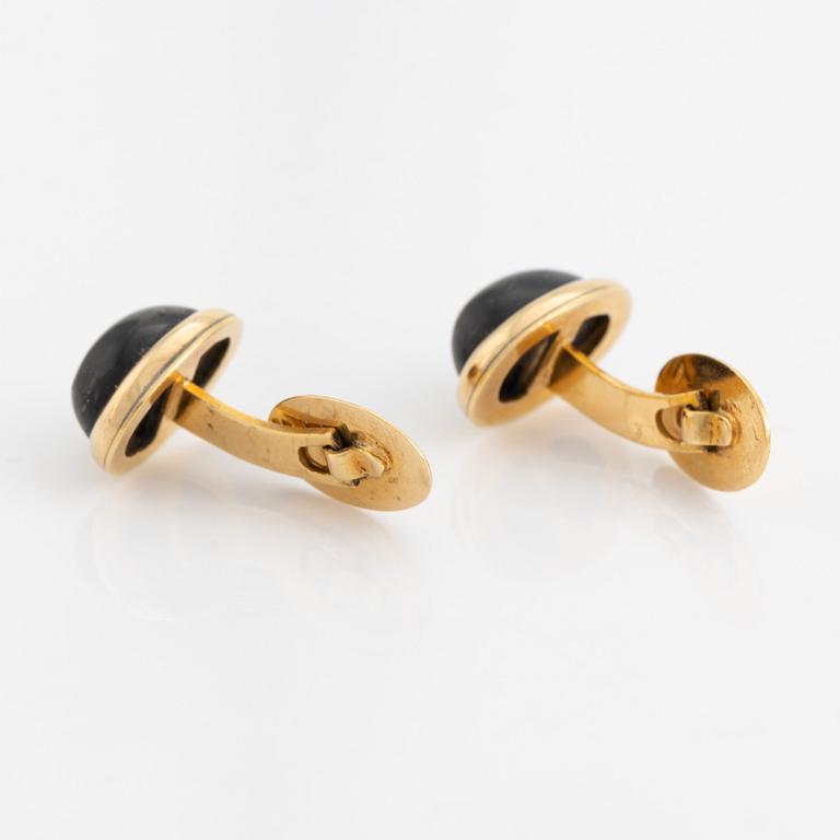18K gold and cabochon cut blue stone cufflinks.