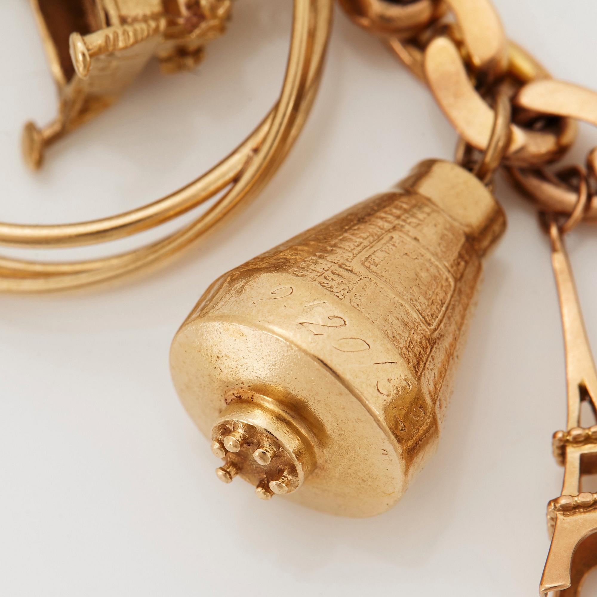 An 18K gold charm bracelet.