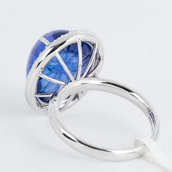 Cabochon-cut tanzanite and brilliant-cut diamond cocktail ring.