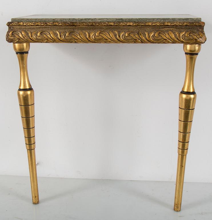 a bronzed mirror and a console table from the second half of the 20th century.