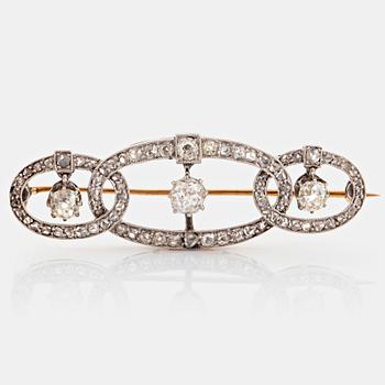 A platinum and gold brooch set with old- and rose-cut diamonds.