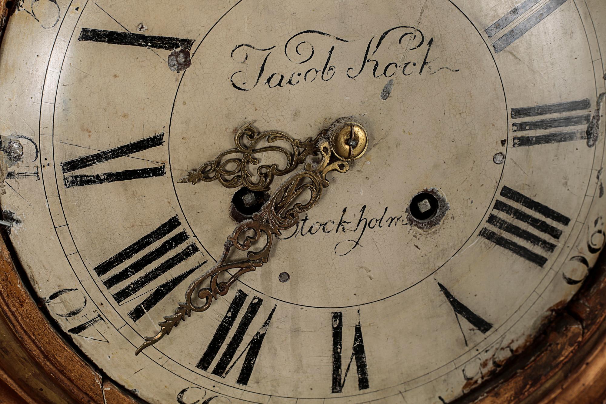 A Gustavian wall hanged clock, dial marked "Jacob Kock Stockholm", maded in the second half of the 18th century.