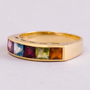 A 18K gold ring with 5 different stones: citrine, amethyst, topaz, garnet, peridot and a small diamond. Probably H.Stern.