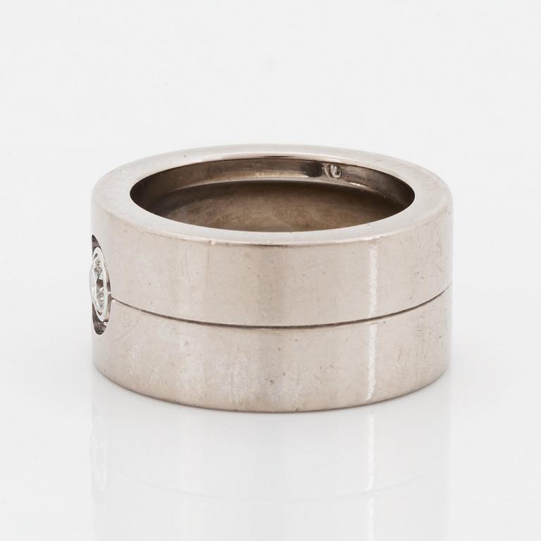 A Cartier 18K white gold ring set with a round brilliant-cut diamond.