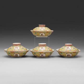 A set of four yellow ground famille rose bowls with covers, early 20th century with Guangxu six character mark in red.