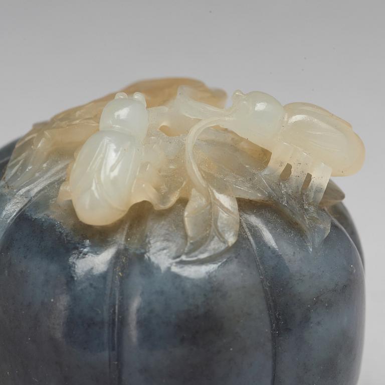 A Chinese nephrite sculpture of insects on a fruit.