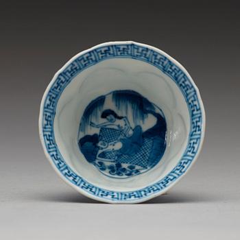 A pair of blue and white "erotic" cups with saucers, Qing dynasty Kangxi (1662-1722).